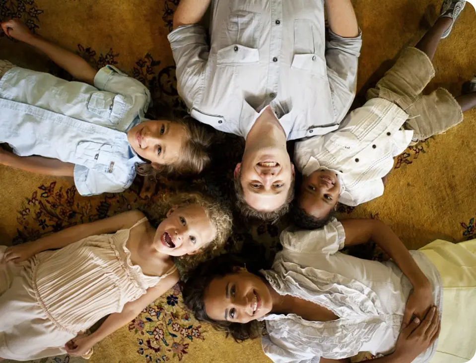 A group of children laying in the middle of a floor.