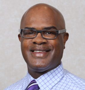 A man with glasses and a tie