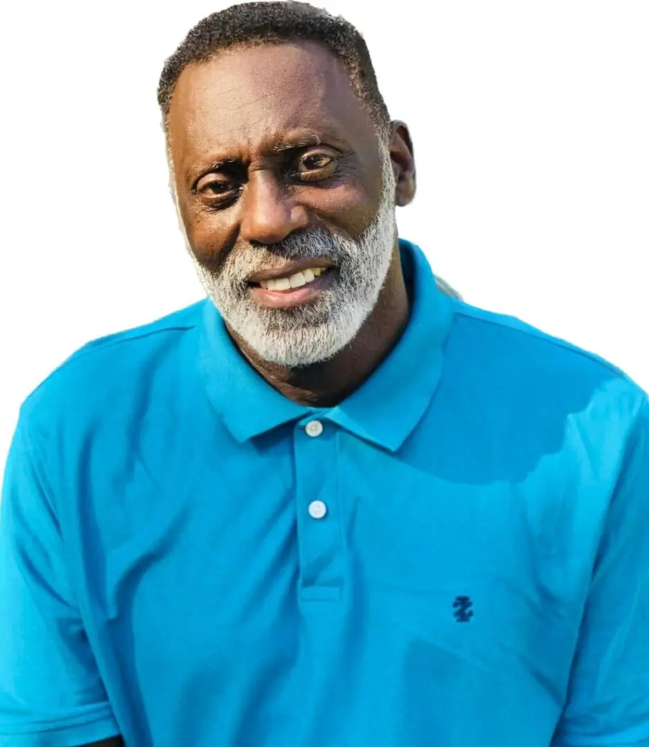 A man in blue shirt smiling for the camera.